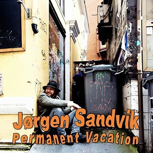 CD cover: man with guitar in an urban alleyway.