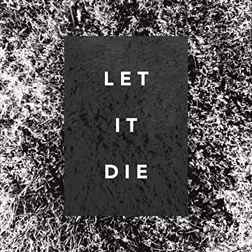 "Black album cover with 'Let It Die' in white text on a grassy background."