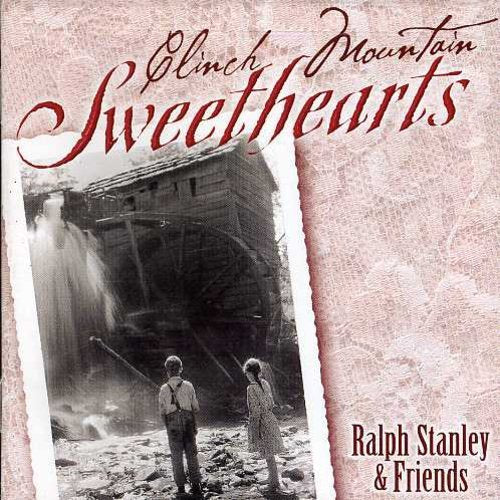 "CD cover with sepia-toned image of couple by a grist mill, red text."