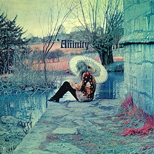 CD cover: woman with parasol seated by a waterway, wintry landscape.
