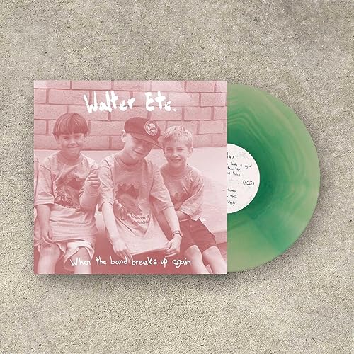 Vinyl record with teal swirl and album cover featuring three boys.