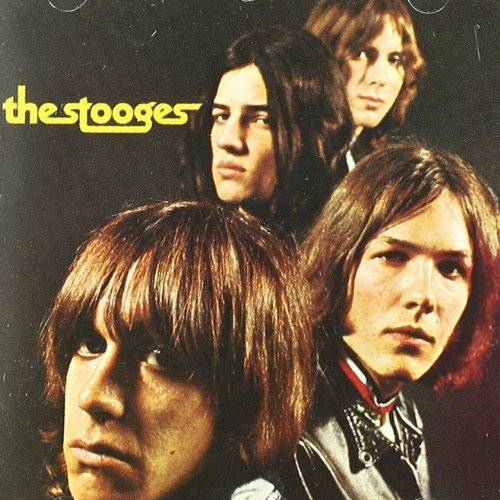The Stooges album cover featuring four men with long hair against a dark background.