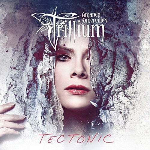 CD cover featuring a woman’s face emerging from cracked stone textures.