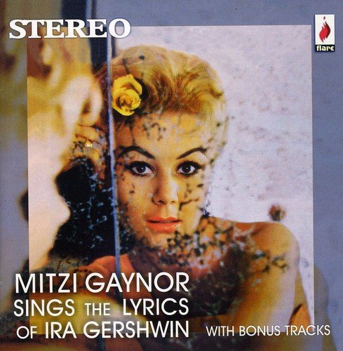 "CD cover featuring a woman with blonde hair and a yellow flower."