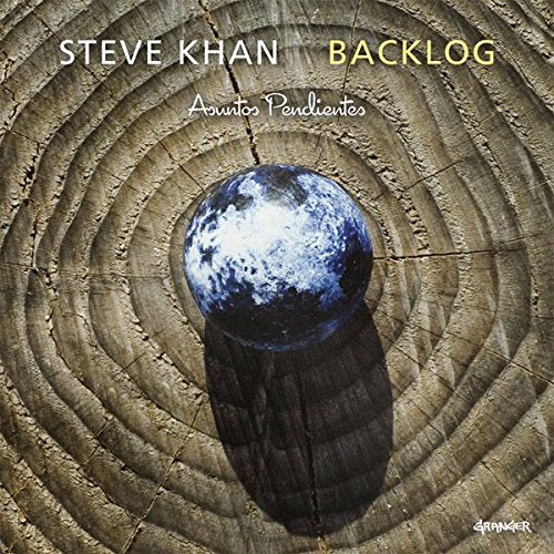 "Album cover with a blue sphere on a wooden surface, displaying concentric rings."