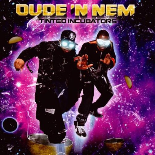 "Album cover with two men in black outfits against a purple galaxy background."