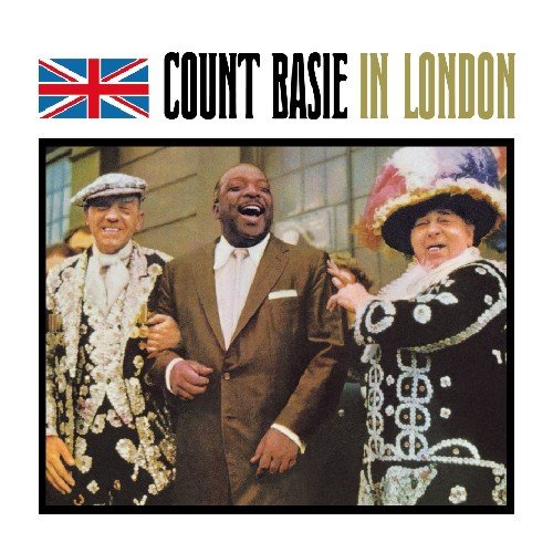 "CD cover with three men, one in a brown suit, laughing together."