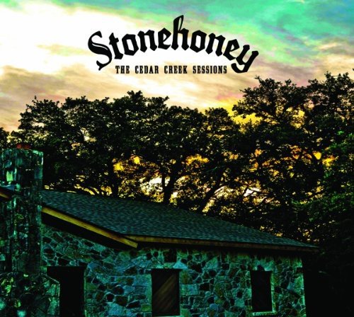 "CD cover art featuring a stone house surrounded by trees at sunset."