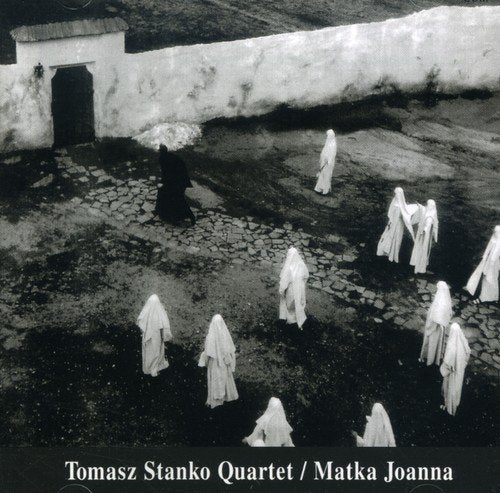 Black-and-white album cover with robed figures walking on a stone path.