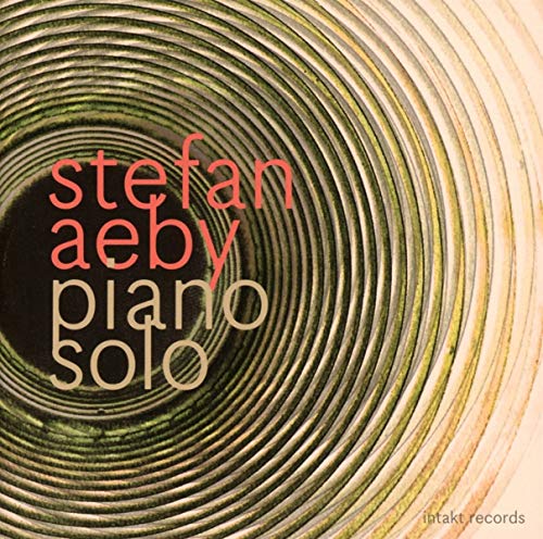 The image depicts a CD cover for "Stefan Aeby Piano Solo" with EAN 7640120193324. For accessibility purposes, a suitable alt text could be: "CD cover with swirling green and beige lines, text 'stefan aeby piano solo'."