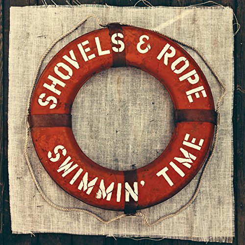 Red lifebuoy with white text on burlap, attached with twine, against a dark background.