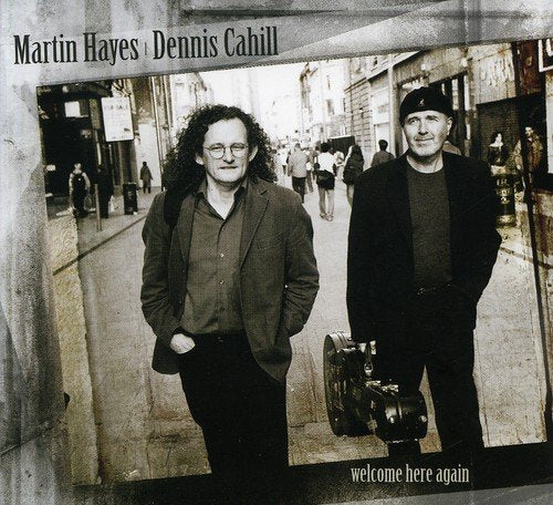 "CD cover with sepia-toned image of two men standing on a city street."