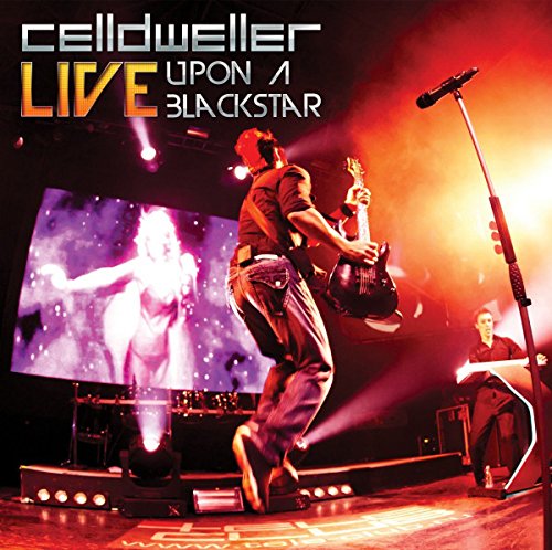Celldweller album cover: musician playing guitar onstage with projected visuals.