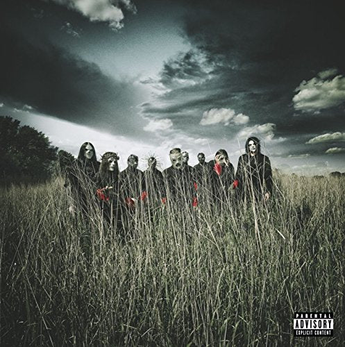 "Slipknot band members in masks standing in a field under a dark sky."