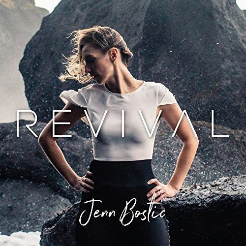 "Album cover with a woman standing on a rocky surface, titled 'Revival' by Jenn Bostic."