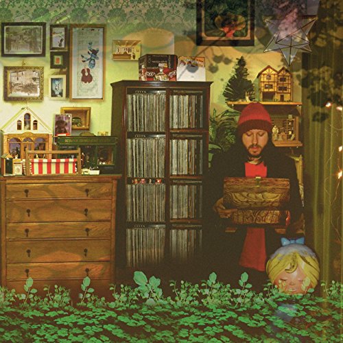 Album cover: man with guitar, child, and cluttered room scene.