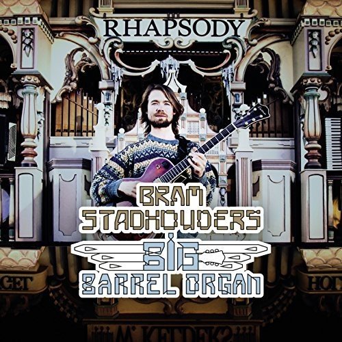 Album cover featuring a man holding a guitar in front of an ornate organ.