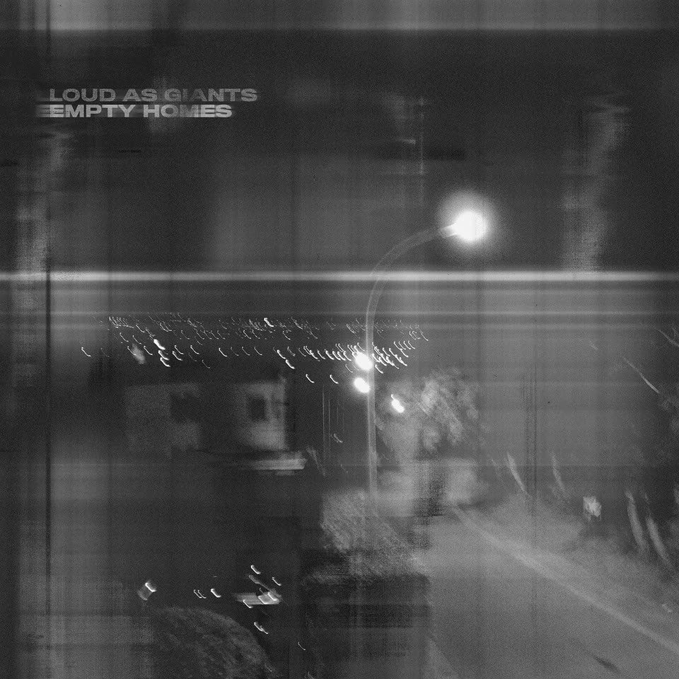 Black and white CD cover with blurred city lights and text.