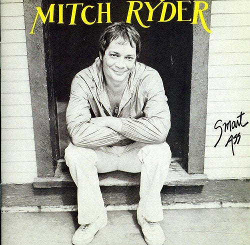 "Black and white album cover with man sitting in doorway, text 'Mitch Ryder' and 'Smart Ass'."