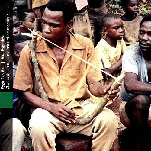 Aka pygmy man playing a musical bow, surrounded by others.
