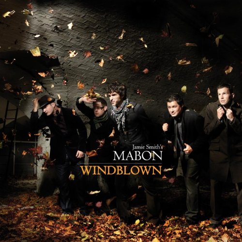 "Album cover featuring four men in dark attire amidst falling autumn leaves."