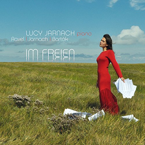A woman in a red dress stands in a green field, holding a white cloth.