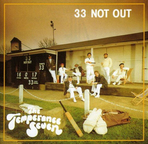 "Album cover with cricket players on a field and a scoreboard, surrounded by a yellow border."