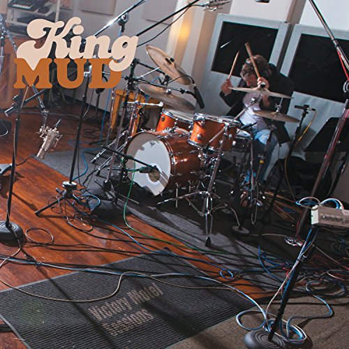 "CD cover featuring a drummer in a studio surrounded by microphones and equipment."