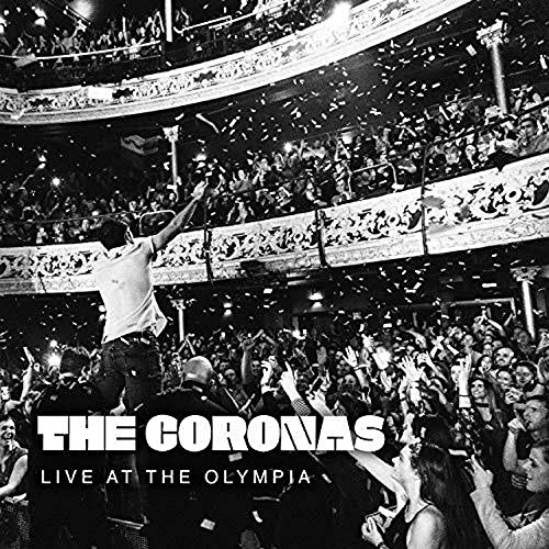 Black and white image of a man on shoulders in a crowded venue with confetti.