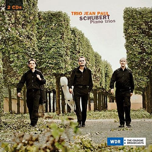CD cover featuring three men in black walking down a tree-lined path.
