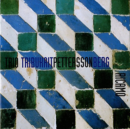 CD cover with a blue and green geometric tile pattern and text.