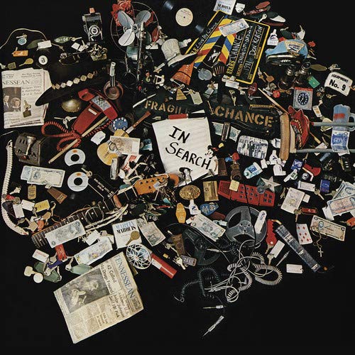 Vinyl record cover: a dense collage of vintage objects on black.
