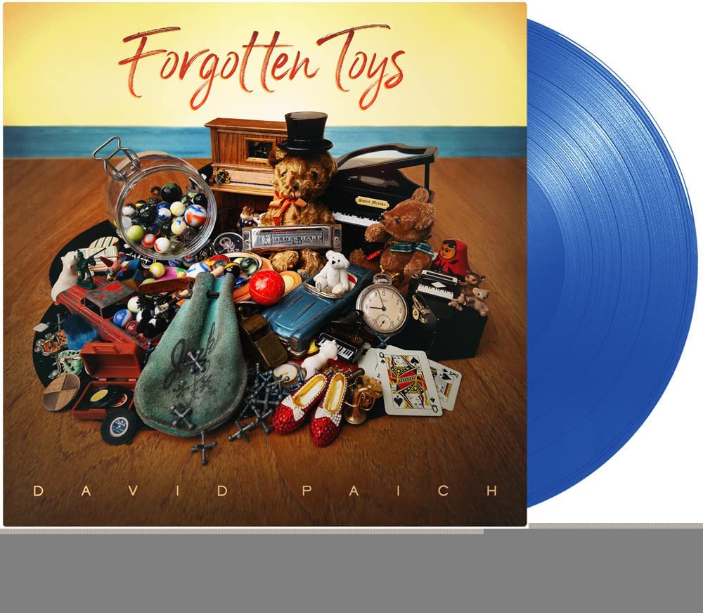 “Forgotten Toys” vinyl record cover with assorted vintage toys and two blue discs.