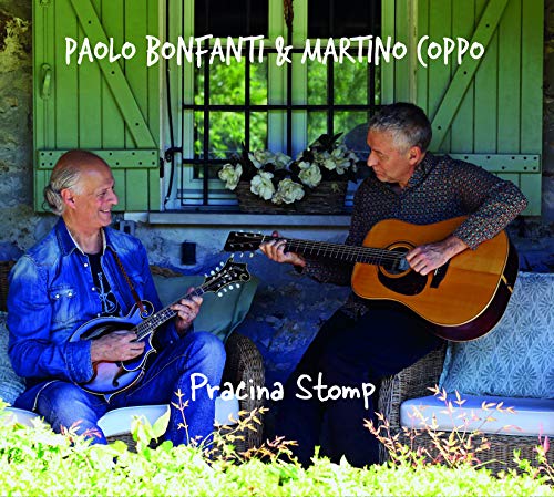 "Album cover: two men playing instruments on a porch with green shutters."