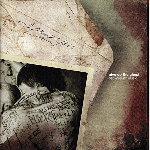 CD cover with a faded photo of two people and handwritten text.