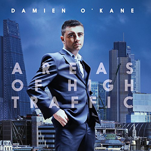 Damien O’Kane album cover featuring a man in a suit with city buildings.