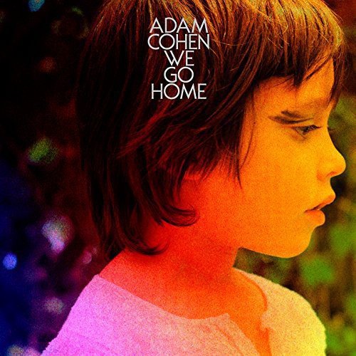 "Album cover featuring a young boy with brown hair, facing right, with multicolored background."