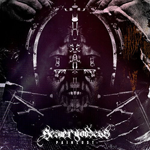 Dark, distorted face within a metallic, circular frame; album cover art.