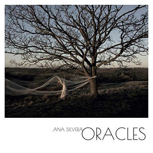 "Album cover with a woman in white tied to a bare tree."
