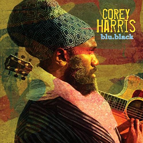 "Album cover featuring Corey Harris with a guitar, wearing a patterned hat."