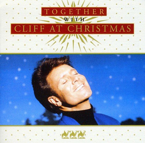 "Album cover featuring a man with dark hair, smiling, against a blue background."
