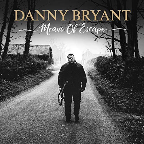 "Album cover with man in dark clothing walking down a rural path."