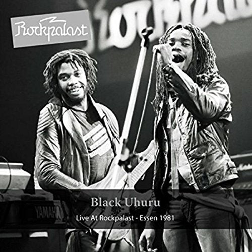 Black and white image of two musicians performing on stage, with text overlays.