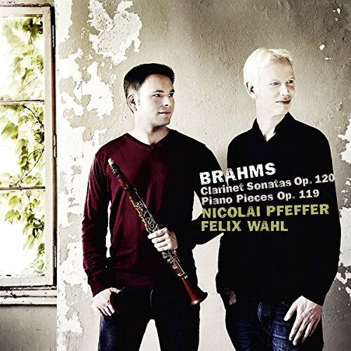 "CD cover featuring two men, one holding a clarinet, against a worn wall."