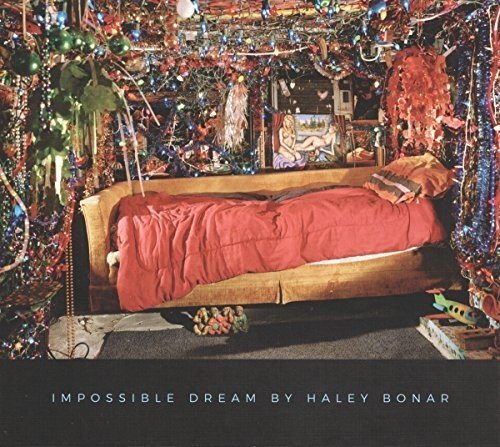 "Album cover featuring a bed in a room decorated with colorful streamers and ornaments."