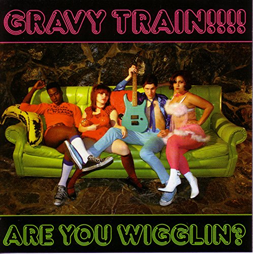 Album cover with four people lounging on a lime green couch in a forest setting.