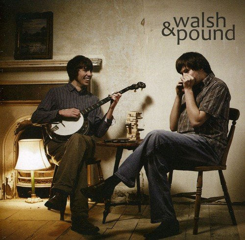 "Album cover featuring two men playing banjo and harmonica in a dimly lit room."