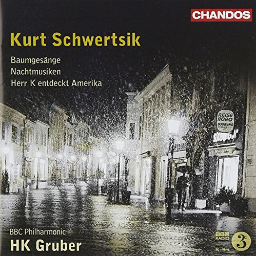 A CD cover featuring a snowy street scene at night with lit buildings.