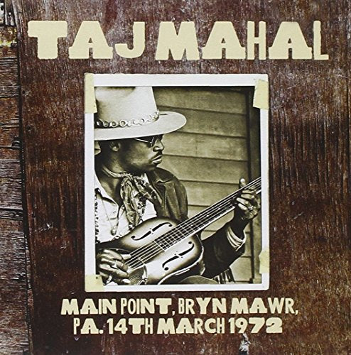 CD cover featuring Taj Mahal playing a guitar, woodgrain background.