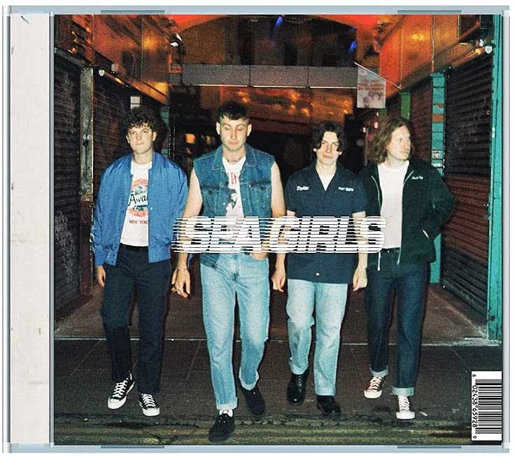 Sea Girls band members standing in a city underpass, album cover.
